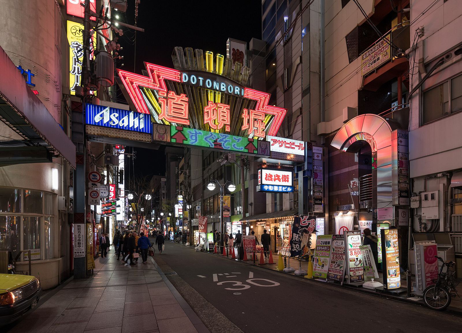Colourful signs and evening foot traffic in Dotonbori