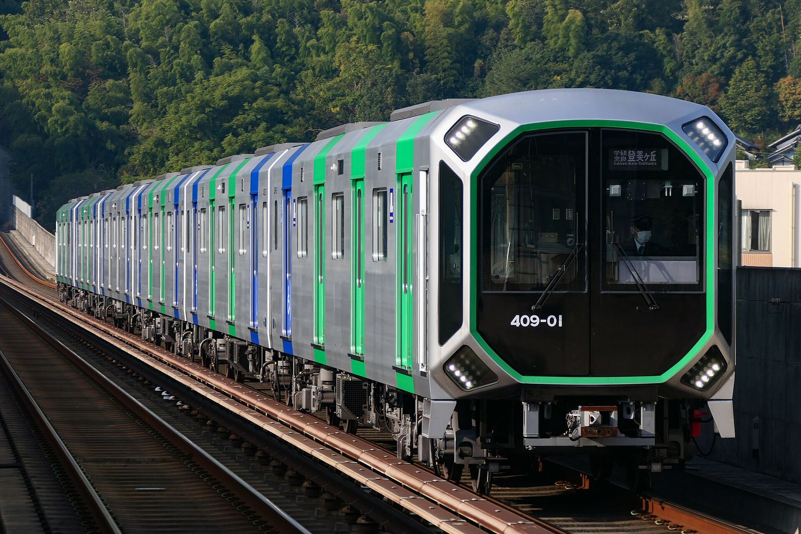 An Osaka Metro train arriving at a station