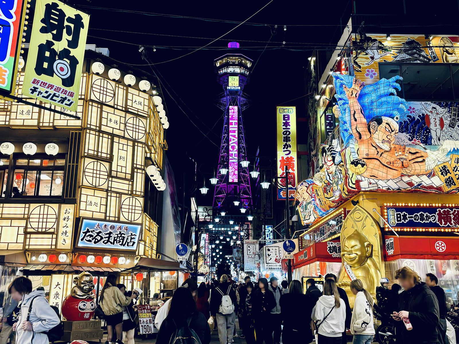 Tsutenkaku Tower glowing above the Shinsekai streets