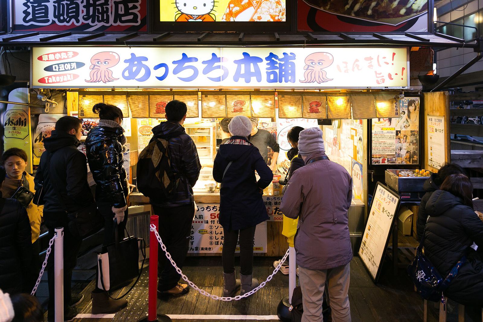 Fresh takoyaki being served at a counter